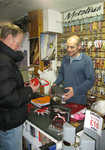 [Ian Barnes and a customer buying crampons at Lakes Climber in Ambleside., 4 kb]