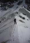 One foot in Kyrgyzstan, one foot in China:  Robert Taylor on the ridge traverse leading to the summit of Mur Samir.  Photo Copy, 3 kb