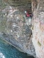 Pete, about to commit to the insecure traverse on 'Dreadnought', Berry Head, S. Devon