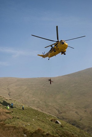 A stretcher being winched in to a SeaKing helicopter  © Mark Reeves