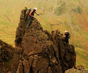 Chris Walker leading a client up the amazing Pinnacle Ridge, Lake District.  © cwalker