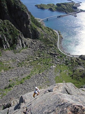 Looking down the top pitch of Lundeklubben (N6) (Puffin Club) (E1 5b) with the Henningsvaer bridges in the background.   © Chris Craggs