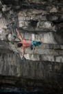 Bob Hickish shaking out while soloing King of the Swingers 7c+, at Cave Hole Portland
