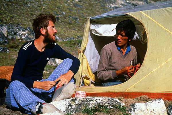 Young Alpinist Andy Cave chatting to Kami Nuru Sherpa , Nepal, 1987.  © Andy Perkins