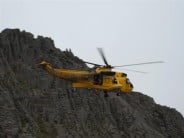 Rescue chopper on excersise, top of fingers ridge behind