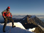 Paul cunningham at the summit of Weismiess, Saas Valley, with the North ridge in the background