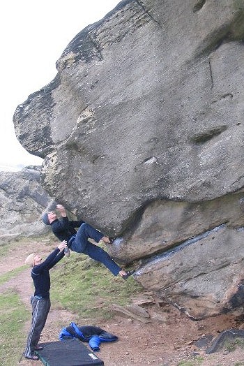 Jim on the front of the Virgin boulder, Almscliff