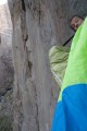 Ian Wilson peeking out of his portaledge on the Hallucinogen Wall, Black Canyon<br>© Jack Geldard