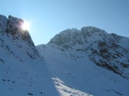 Sun peeping round Pikes Crag, Scafell group