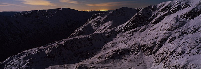 From Striding Edge toward Nethermost and Dollywagon Pike the west coast neon strip of Morecombe and Blackpool on the horizon.  © Alastair Lee