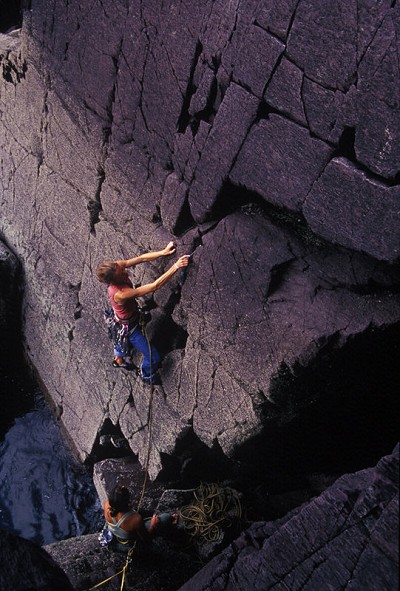 The belayer is safely attached as Libby  sets off on the delightful Red Wall, Severe, Porth Clais,  Pembroke  © Mike Robertson