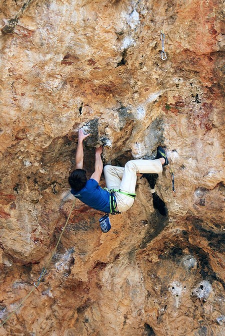 Young Jonny Stocking contorts through the crux on  Rollito Sharma F8b+  © Alan Cassidy
