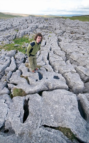 Adam Ondra exploring the deeply eroded limestone pavement atop Malham Cove in Yorkshire  © Vojtech Vrzba