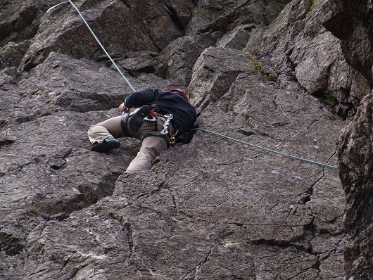 Thom crosses the tricky slab of Murray's Route   © Chris Austin