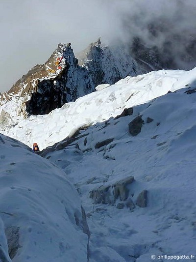 Jean-Marc in the mixed terrain at around 6100 m, C2 behind  © P. Gatta
