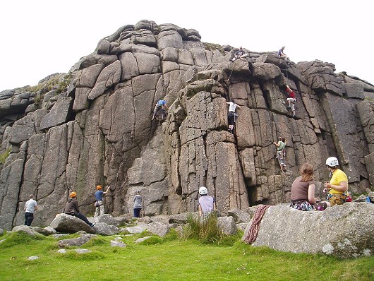 Tracey watching climbers on Slab Route, Omega Crack, Overhang Crack & Dandelion. Sheeps Tor, Dartmoor.  © Blackgoby