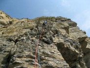 Luca on P1, with the bottomless arete of P2 on the top-right.