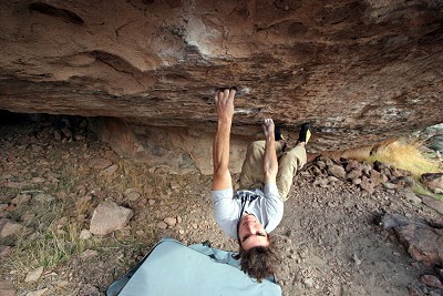 Dan Mills on the ceiling of Goldfish Trombone V13, a powerful small pocket and pinch problem, Happy Boulders.  © Tim Steele
