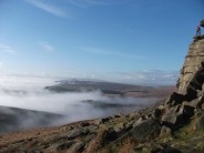 Climbing above the clouds at Stanage.
