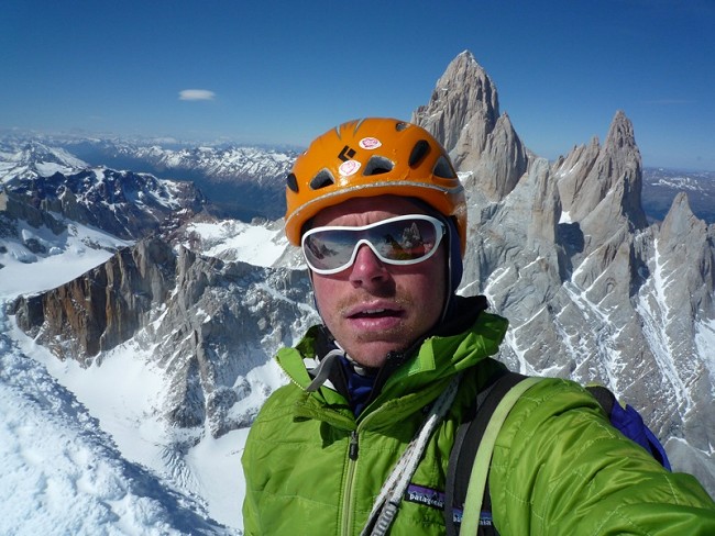 Colin Haley: Self portrait on the summit, with Fitz Roy and Poincenot behind.  © http://colinhaley.blogspot.com/