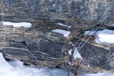 A typical belay on the Eiger North Face - Insitu old pegs litter the route, but other protection is scarce.  © Jack Geldard
