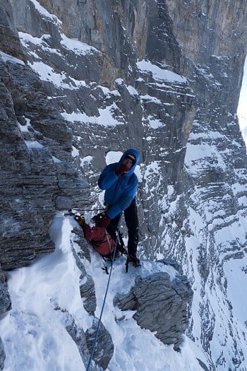 Rob Greenwood tucks in to a cheese butty to ready himself for the Difficult Crack, Eiger North Face.  © Jack Geldard