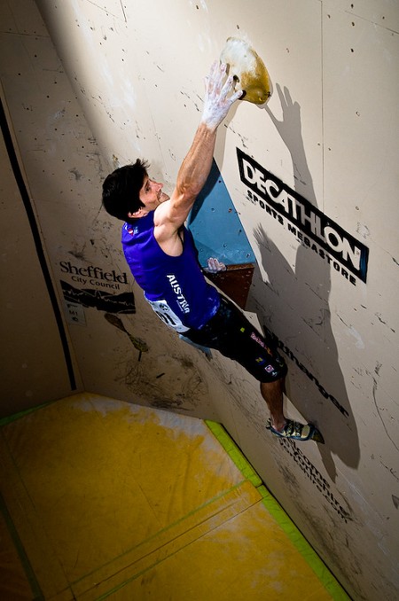Men's winner was Kilian Fischuber of Austria, seen here undercutting the flared jam slot on problem 1!  © Keith Sharples Photography