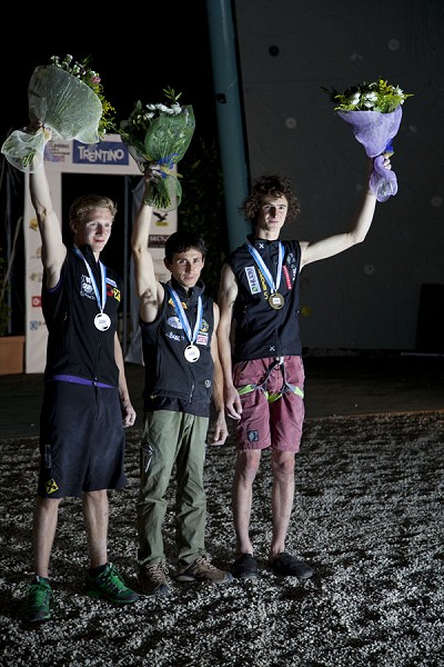 Jakob Schubert, Ramón Julian Puigblanque and Adam Ondra raise their victory flowers aloft.  © Jack Geldard