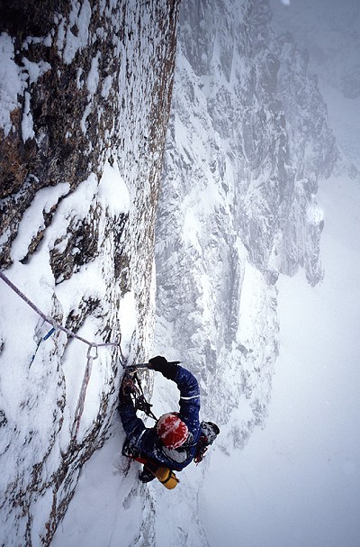 Ian Parnell cleaning an A4 pitch in Scottish conditions on the Lafaille Route.  © Andy Kirkpatrick/Vertebrate Publishing