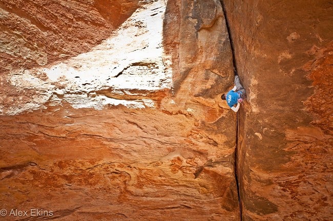 Tom Randall climbing Century Crack placing the gear on lead  © Alex Ekins - No reproduction on other media without permission