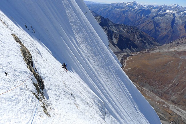Dave Turnbull climbing the summit ice slopes on the first ascent of Gojung  © Mick Fowler and Dave Turnbull