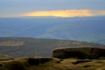 The January sun shines through the clouds at Stanage