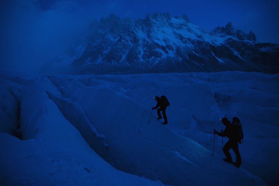 David Lama and Daniel Steuerer hiking their way through the Argentinean night  © Corey Rich/Red Bull Content Pool