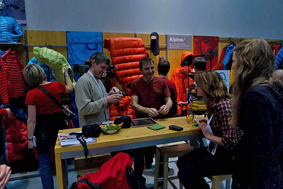 Ueli Steck chatting with Alan James and Sarah Stirling on the Mountain Hardwear Stand - ISPO 2012  © Mark Glaister