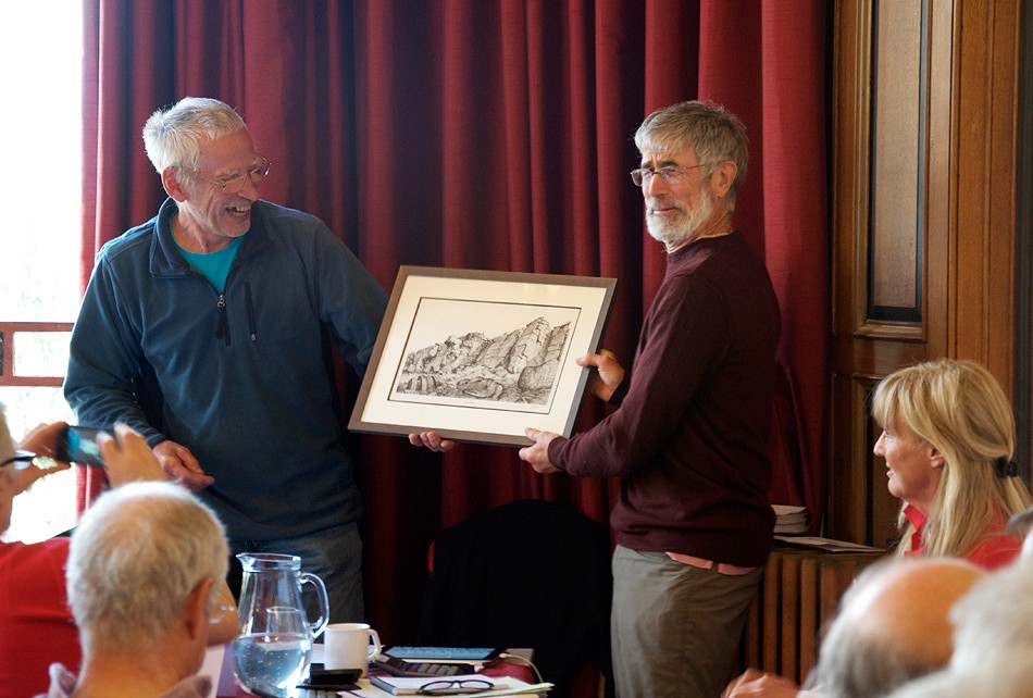 Scott Titt, the new BMC President hands Rab Carrington the retiring BMC President, a Phil Gibson crag drawing.  © Mick Ryan - Senior Editor - UKC and UKH