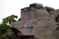 Stretching for the hold on Eraser Slab at Earl Crag