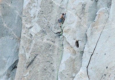 Alex Honnold following Hans Florine on their speed ascent of The Nose. Alex has loops of rope over his shoulder.  © Tom Evans / El Cap Report