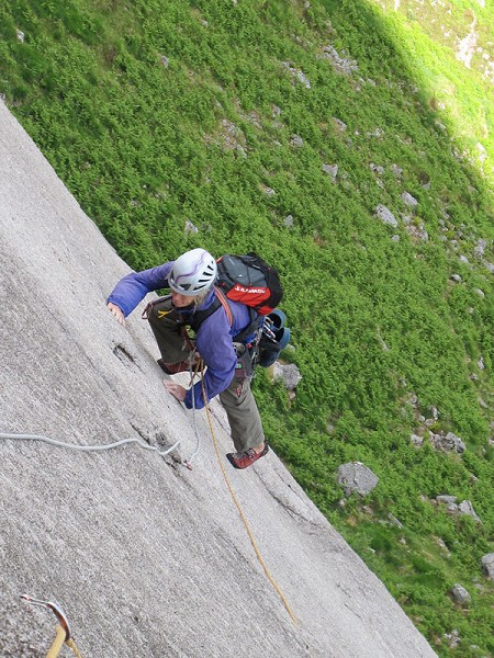 Clare contemplating the ‘long reach’ move to the flake on pitch 4  © Neil Foster