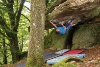 James Squire reaching for the lip on Jungle V.I.P (font 8a) at Burrator Reservoir, Dartmoor.