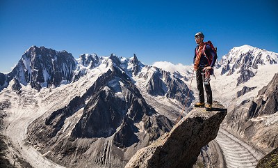 Simon Birkebæk on the summit of Aiguille du Moine with Grandes Jorasses and Mt. Blanc in the background. Chamonix, France  © Ulrik Hasemann
