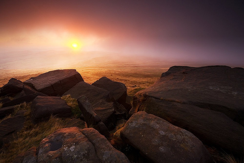 A gap in hill cloud at sunrise, allows the sun to light up the mist around West Nab, Meltham Moor.  © Andy Hemingway