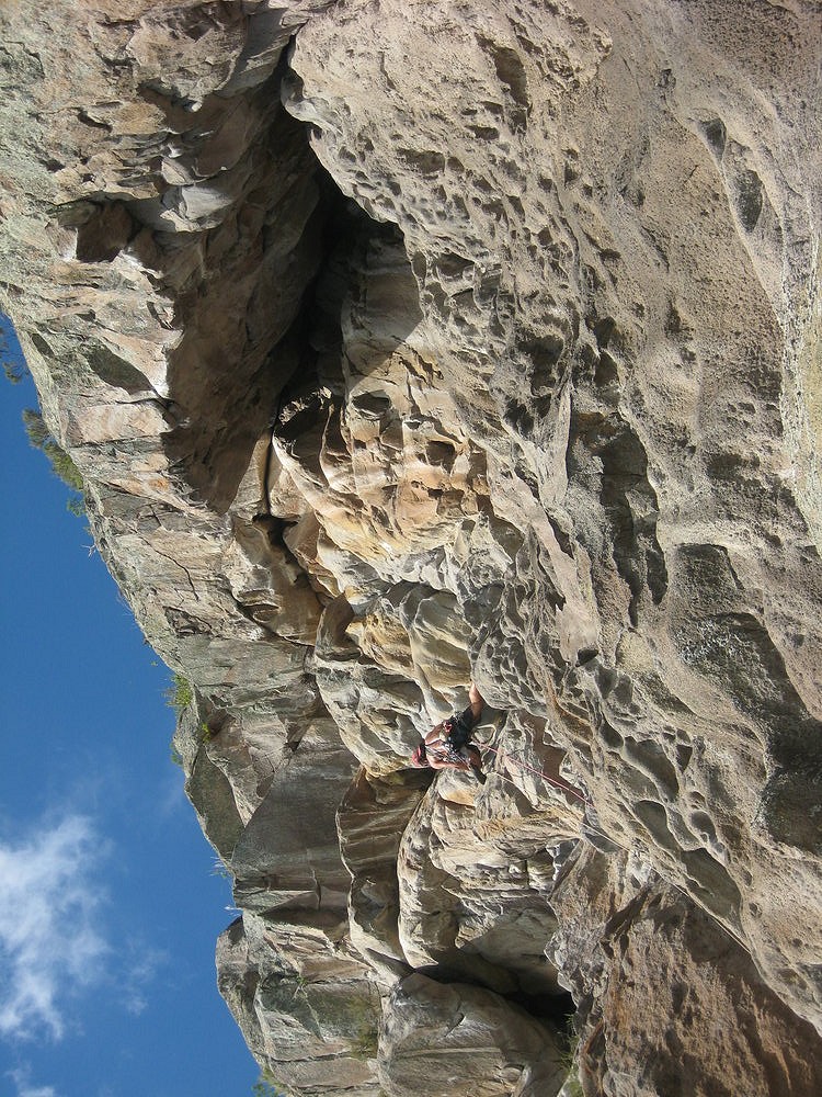 Dan Head on a ground up trad FA 3 pitch E5, through the roofs above him.  © RobNZ