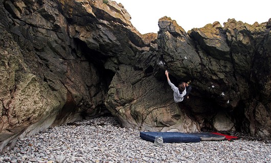 James Squire seaks out an amazing overhanging prow at Sand Point.  © Beastly Squirrel