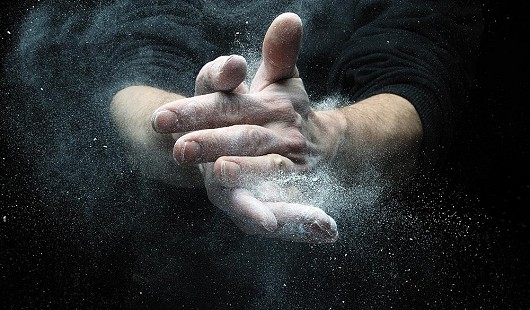Climber chalking his hands. This image was taken with a fast flash duration.  © neal grundy photography