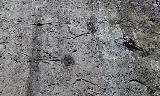 Climber stretching for that next crimp on Right Wall at Dinas Cromlech  © kasiab