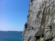 Steve Foxley setting off on the classic Sea Mist HS 4b at Saddle Head, Pembroke.
