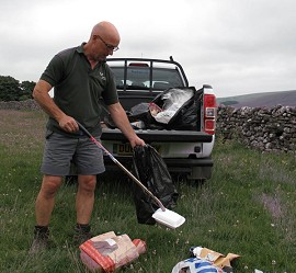 Ranger Richard Mainman clears up the mess  © Yorkshire Dales National Park Authority