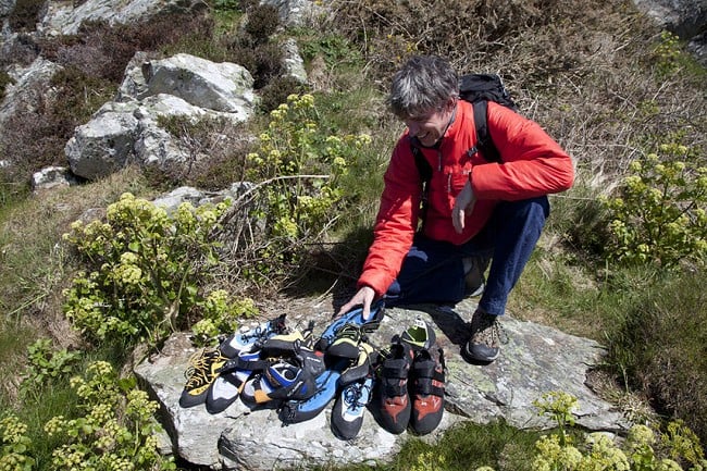 Alan James at Holyhead Mountain, with a big pile of shoes on test  © UKC Gear
