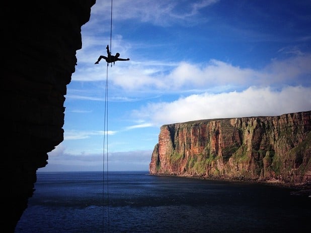 Becky doing her aerial abseiling routine on the Old Man of Hoy!  © Jon Garside