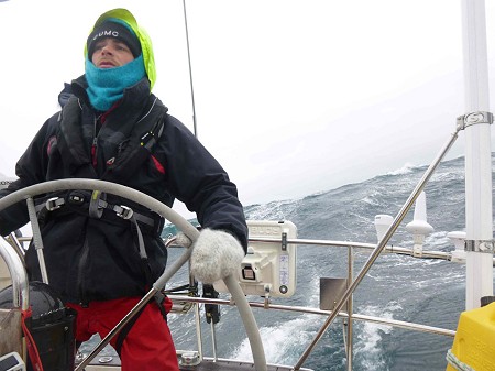 Peter steering the boat during a gale!  © Jacob Cook Collection